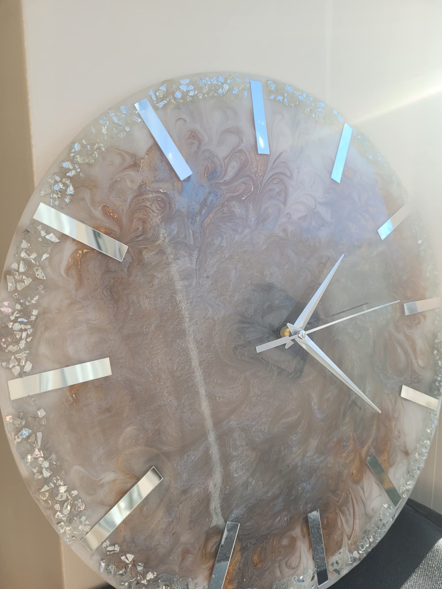 Decorative wall clock with a floral design on a plain background