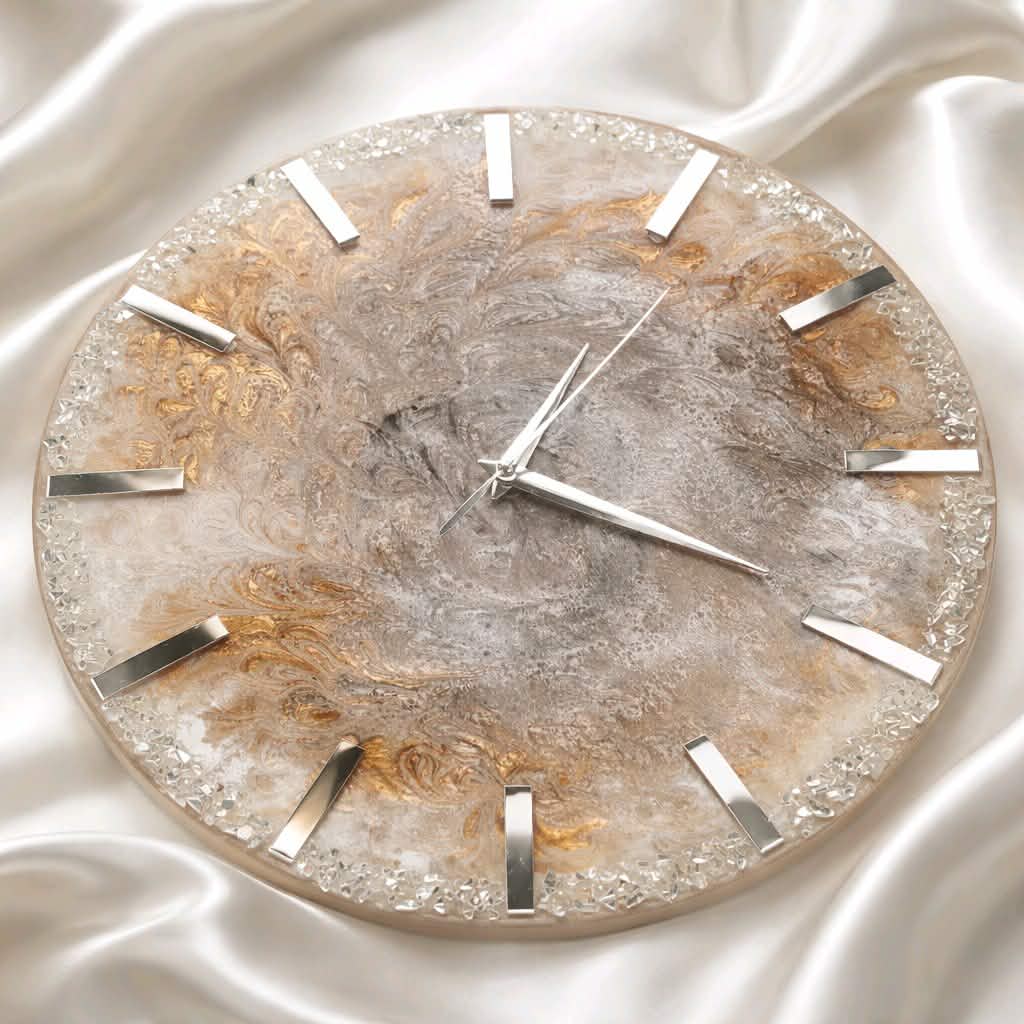 Decorative wall clock with a metallic design on a textured white background