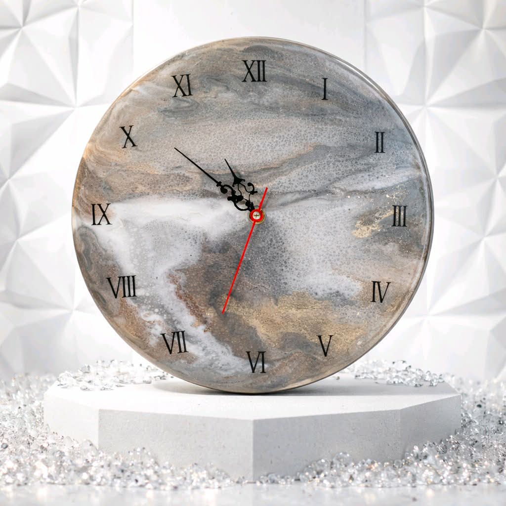 Round clock with marble design on a white background