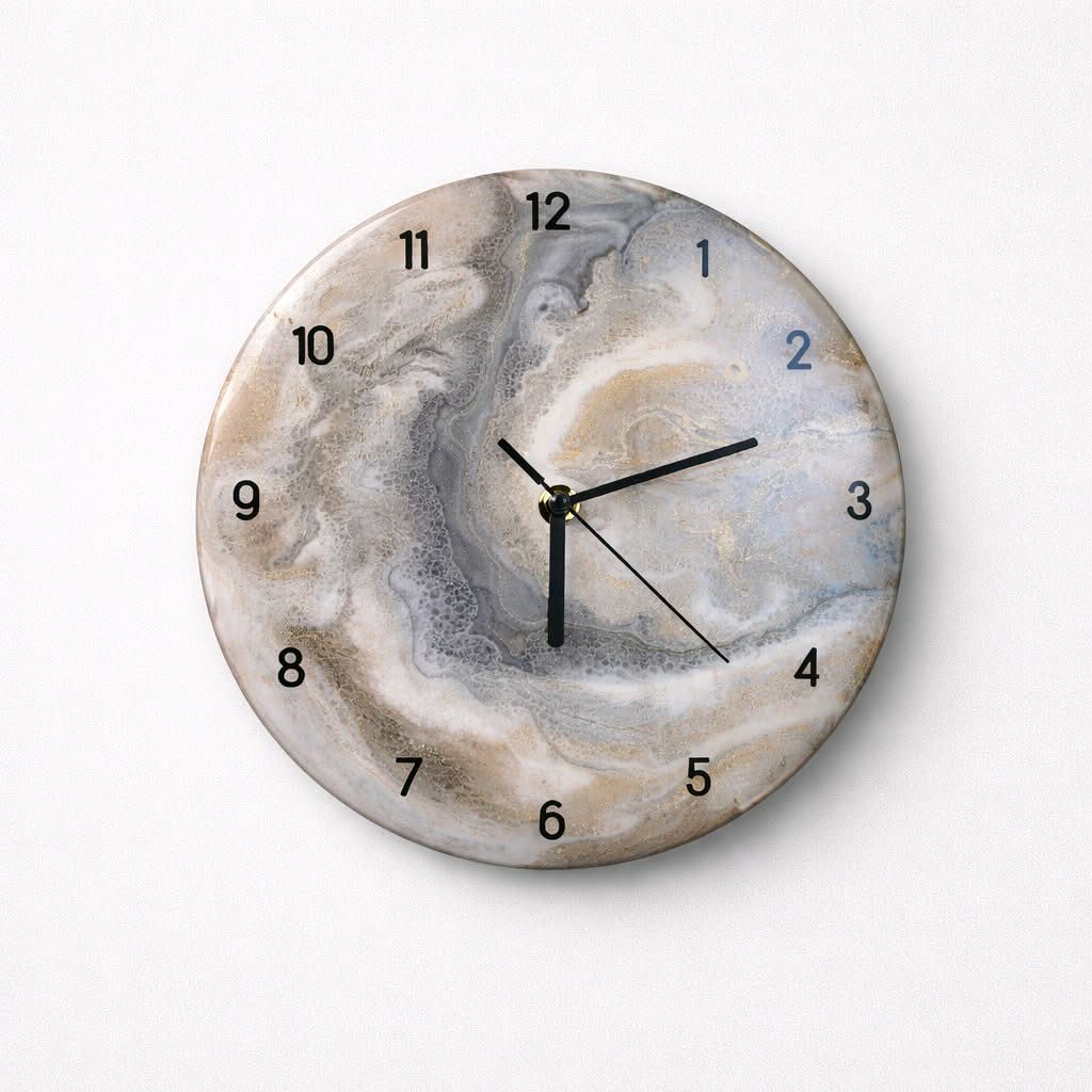 Round wall clock with a marble-like design on a white background