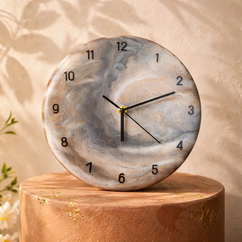 Round marble clock on a wooden stand with a beige background