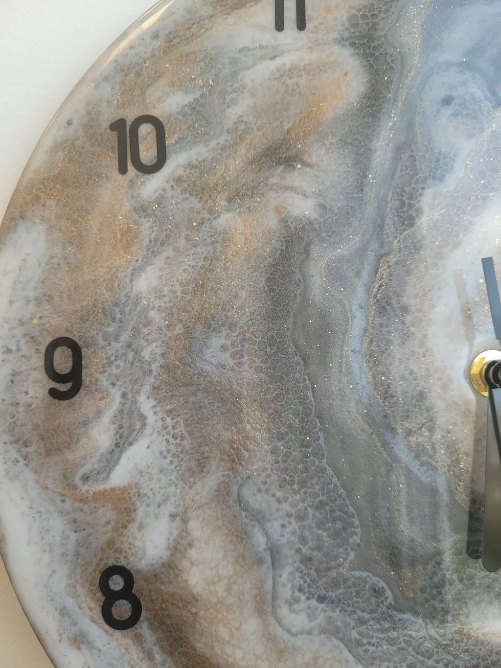 Marble-patterned clock with gold accents on a white background