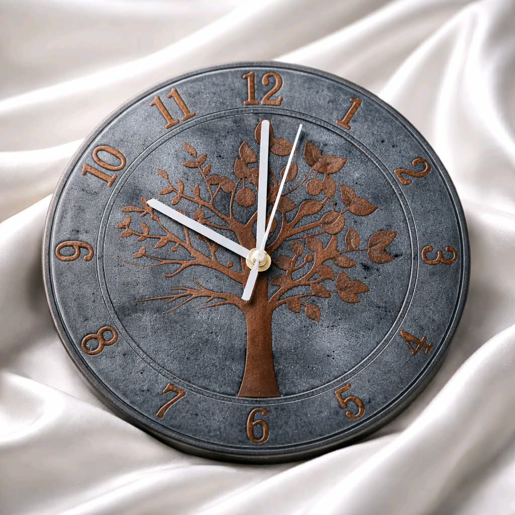 Decorative wall clock with tree design on a white fabric background