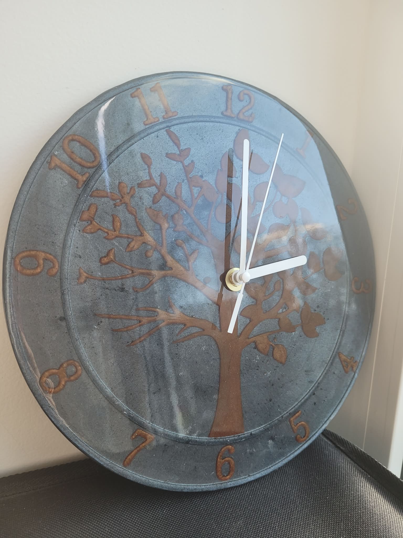 Wall clock with tree design and metallic finish