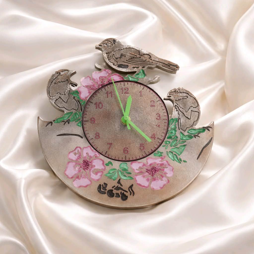 Decorative clock with birds and flowers on a satin background