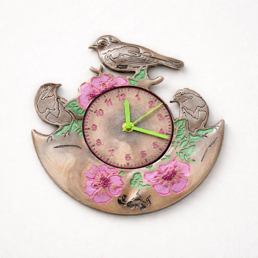 Decorative wall clock with birds and flowers on a white background