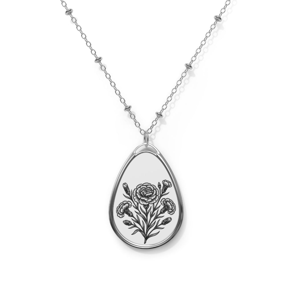 Teardrop-shaped pendant with floral design on a chain against a white background