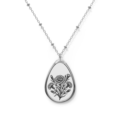 Teardrop-shaped pendant with floral design on a chain against a white background