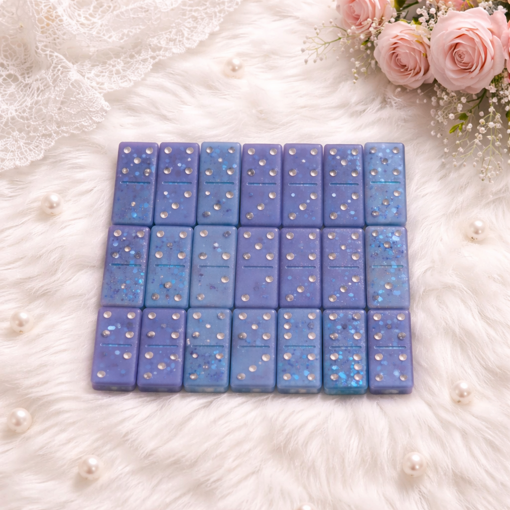 Blue glitter resin domino pieces, close-up detail