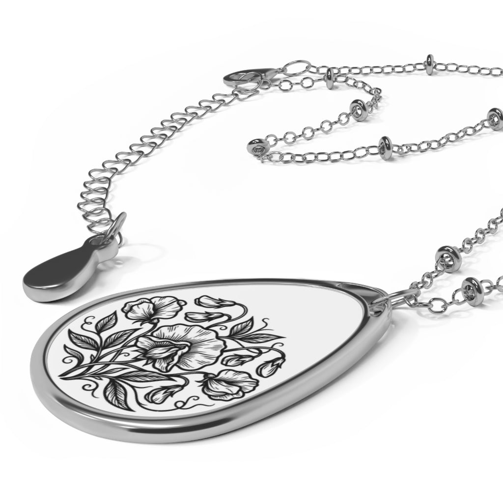 Teardrop-shaped pendant with floral design on a white background