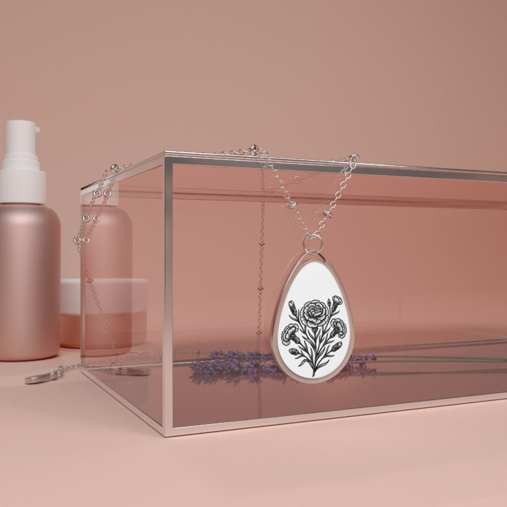 Silver necklace with a floral pendant on a pink background