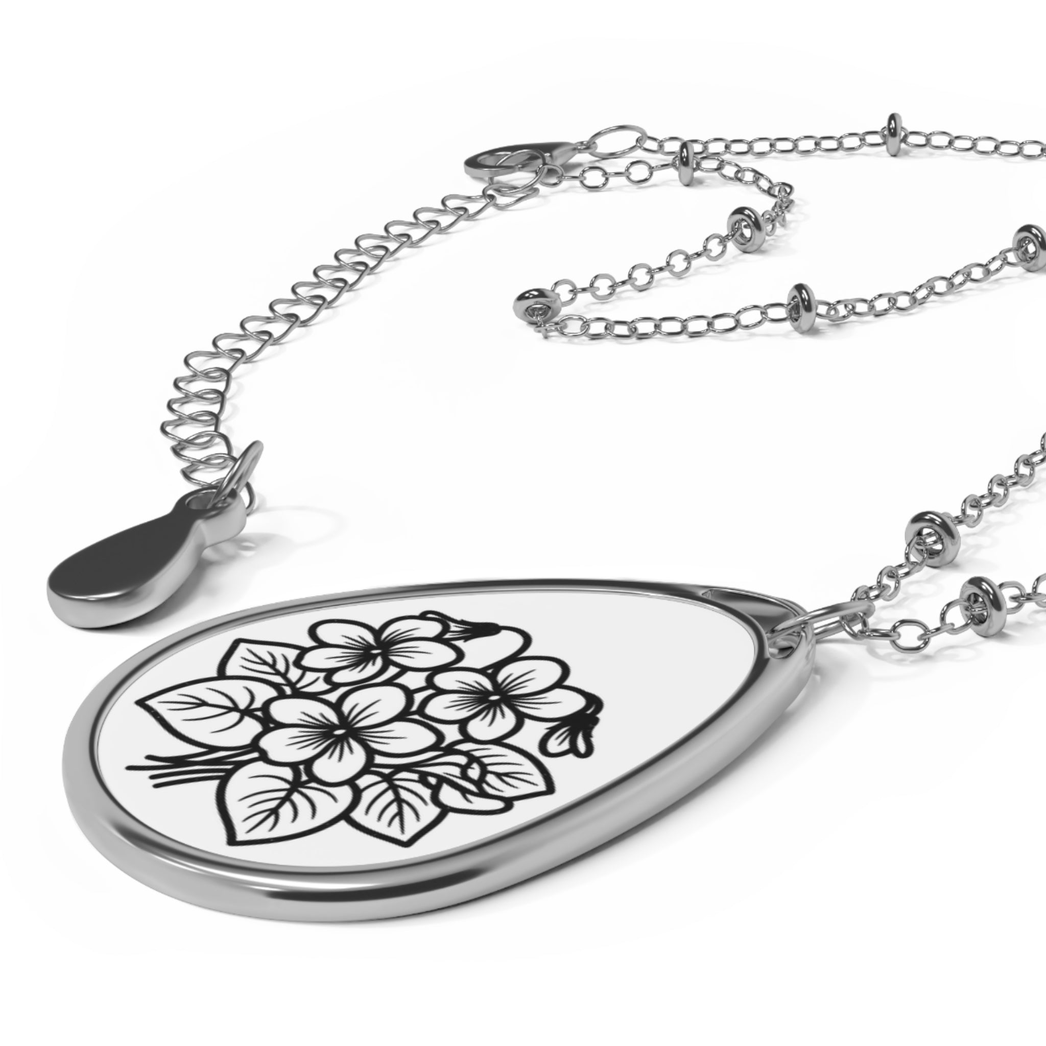 Teardrop-shaped pendant with floral design on a white background