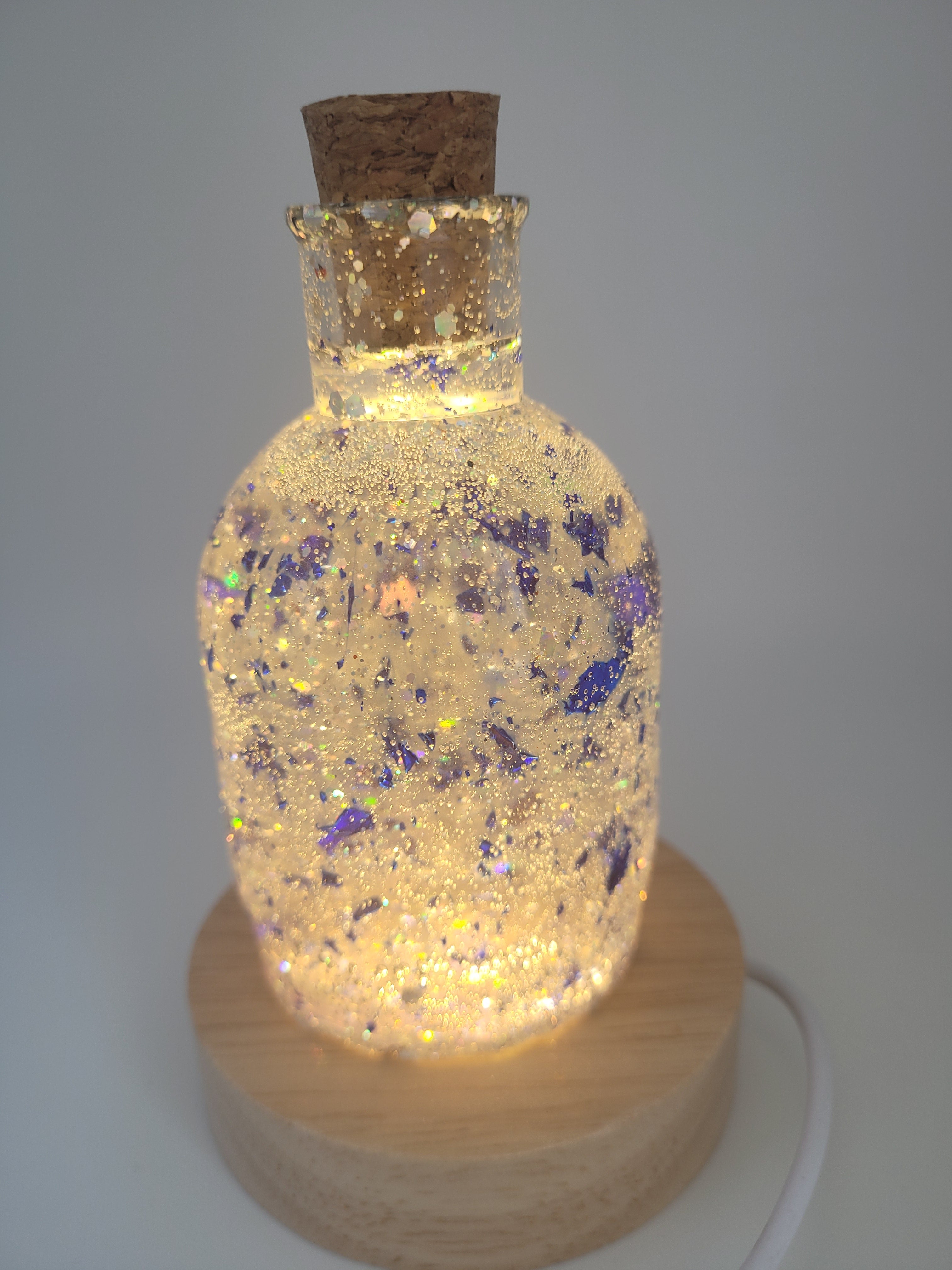 Decorative bottle with cork stopper on a gray background