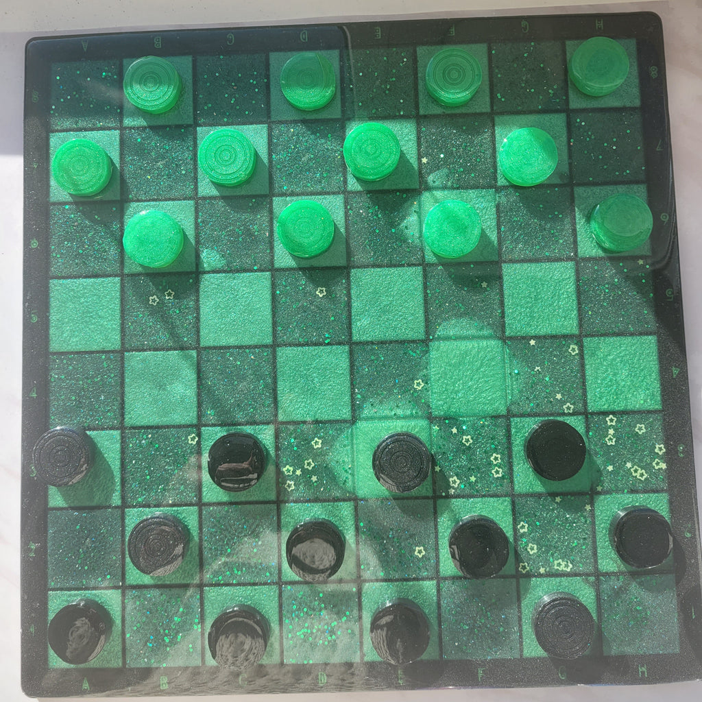 Checkers board with green and black pieces on a white background
