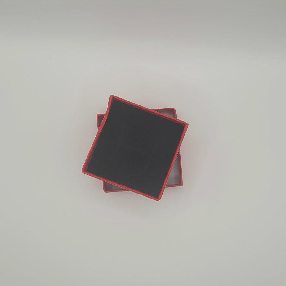 Black square gift box with red borders on a white background