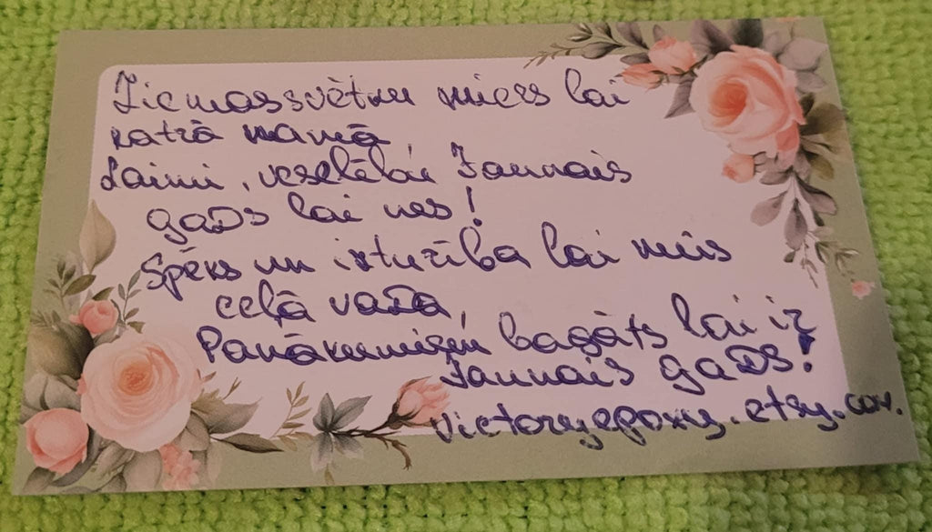 Handwritten message on a decorative card with floral elements on a textured green background