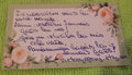 Handwritten message on a decorative card with floral elements on a textured green background