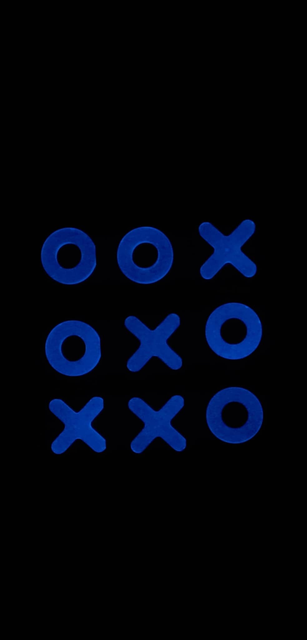 Glow in the dark resin tic tac toe pieces, close-up detail