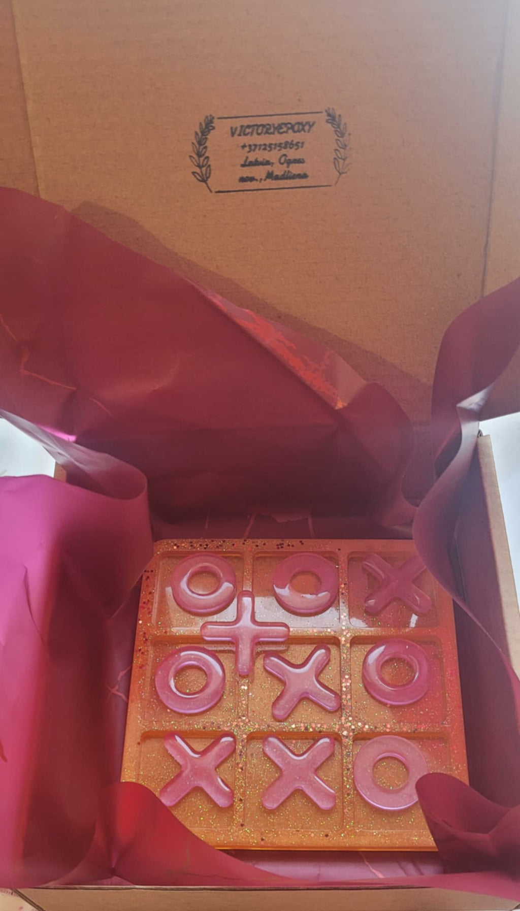 Wooden letterpress block with 'LOVE' and 'XOXO' printed on it, inside a box.