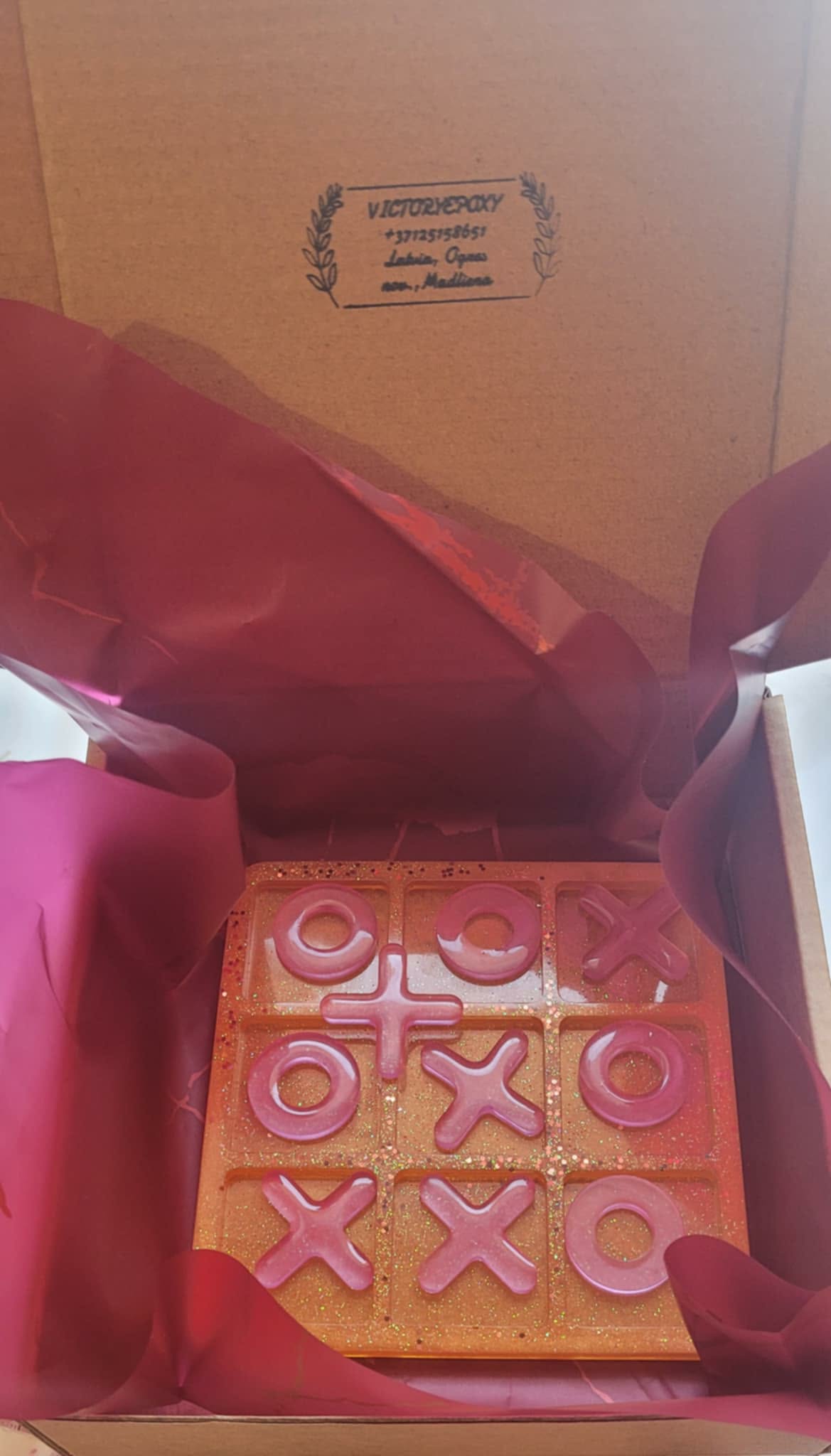 Wooden letterpress block with 'LOVE' and 'XOXO' printed on it, inside a box.