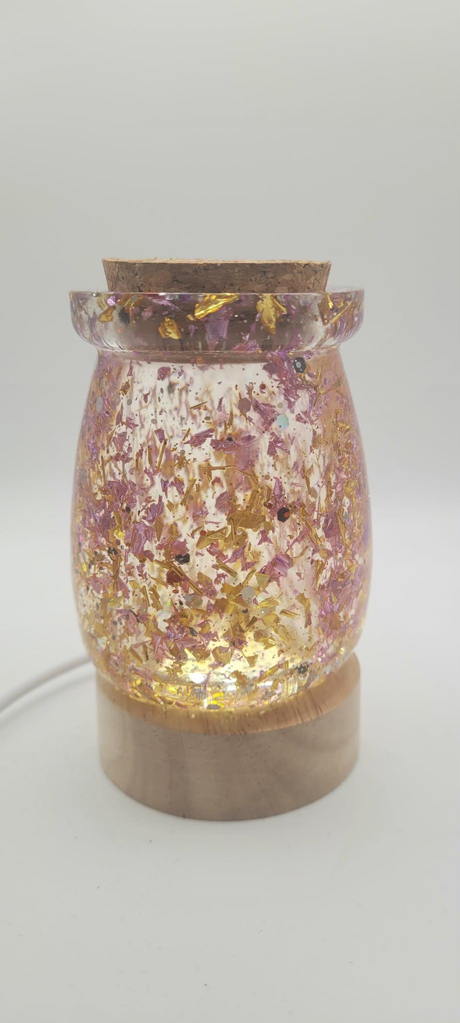 Decorative lamp with floral design and wooden base on a white background