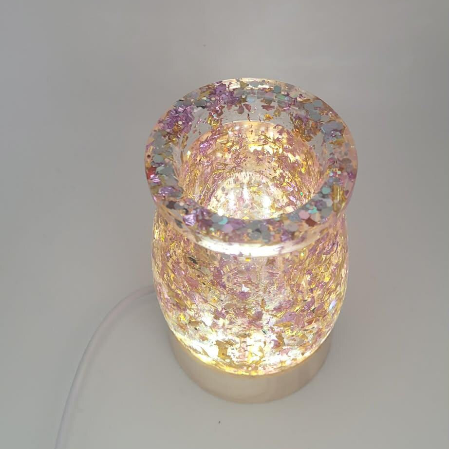 Decorative candle holder with a glowing light on a white background