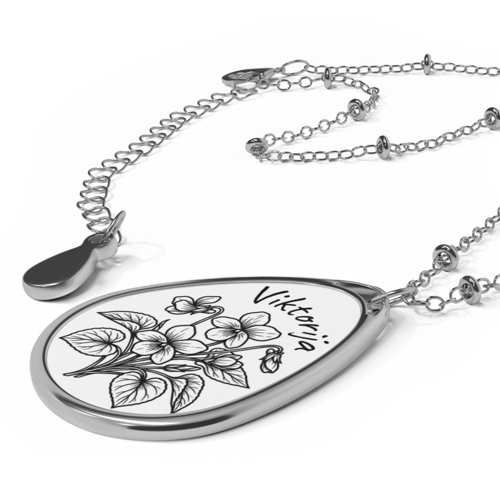 Teardrop - shaped pendant with Violet Floral engraved on a white background.