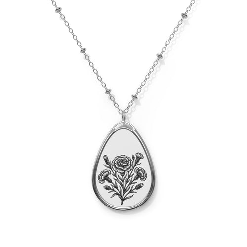 Teardrop - shaped pendant with floral design on a chain against a white background.