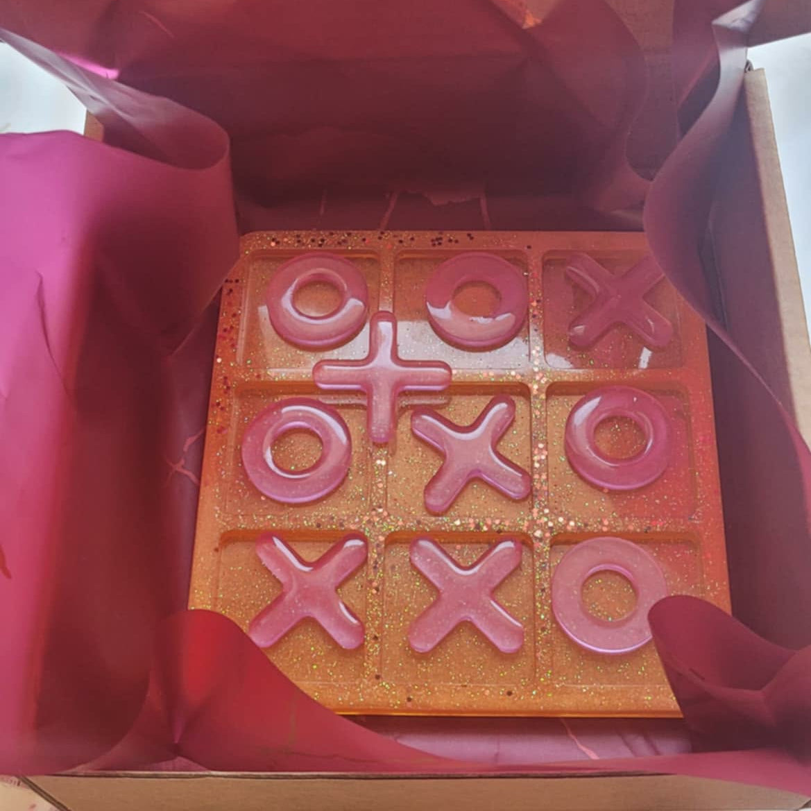 Wooden letterpress block with 'LOVE' and 'XOXO' printed on it, inside a box.