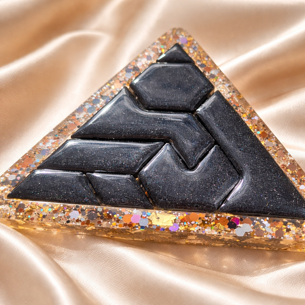 Black geometric design on a glittery gold surface