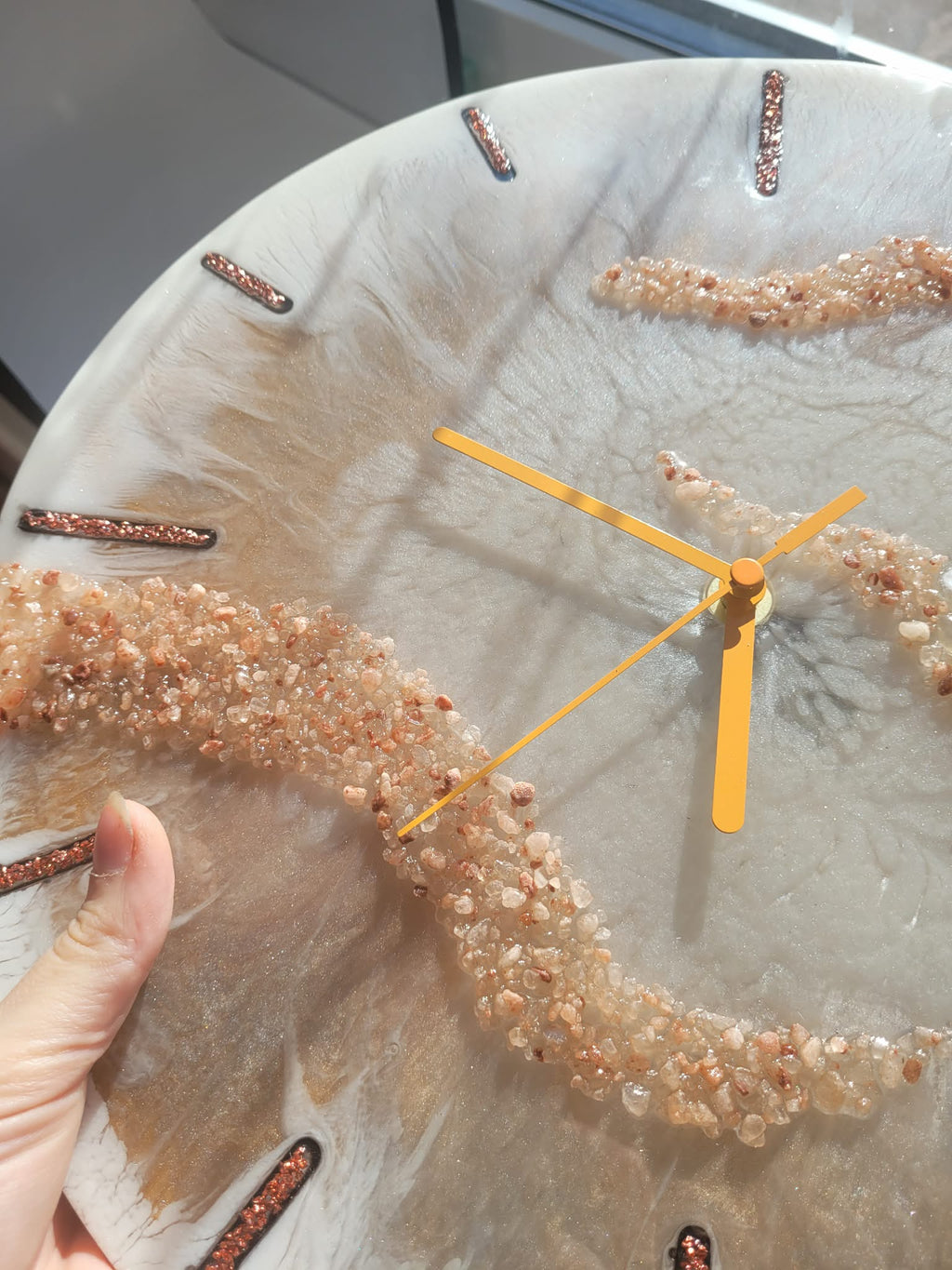 Handmade white and gold resin wall clock, texture close-up