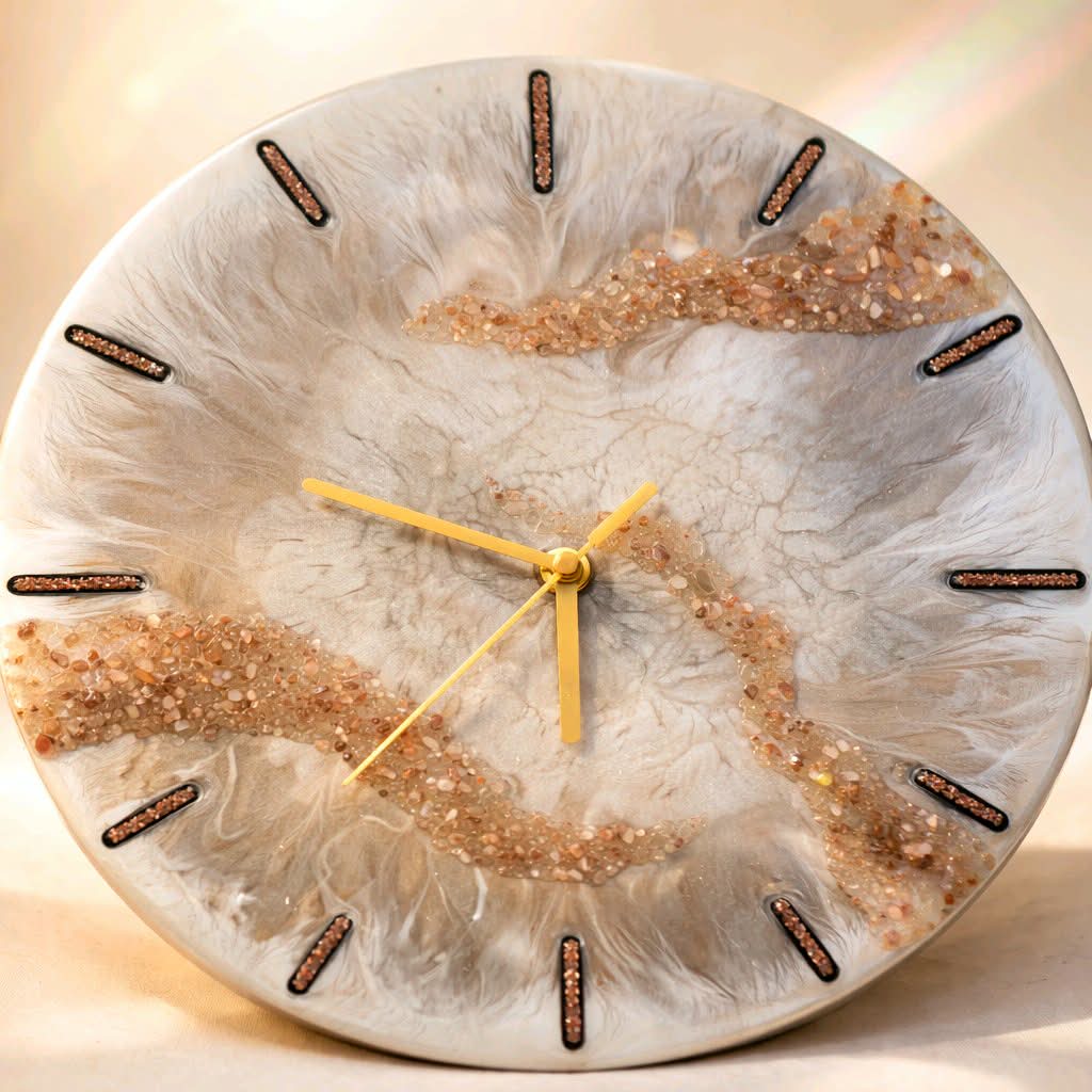 Round clock with a decorative face featuring gold and brown colors on a light background