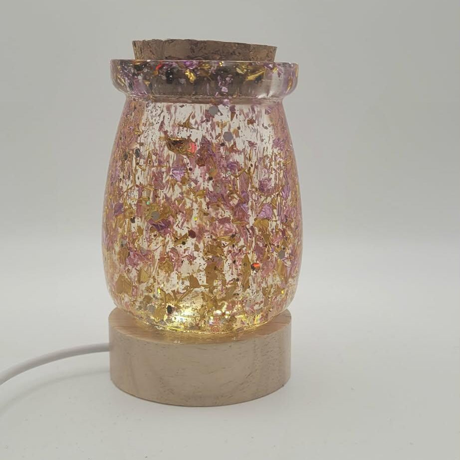 Decorative lamp with glittery top and concrete base on a white background