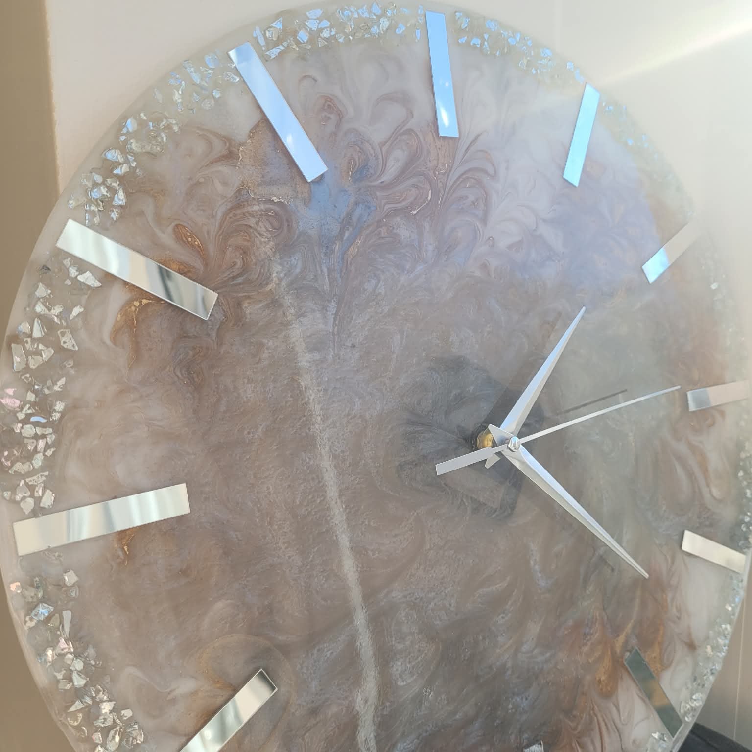Decorative wall clock with a floral design on a plain background