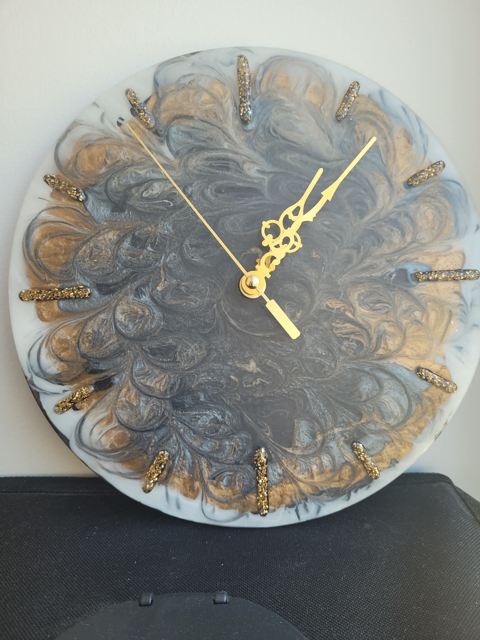 Decorative clock with gold accents on a white background