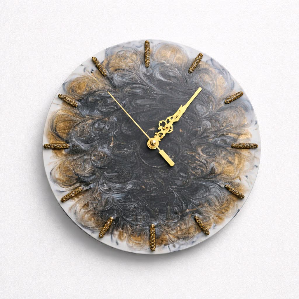 Round wall clock with marble design and gold accents on a white background